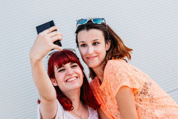 istock Two best friends having fun and making selfie 1307410042