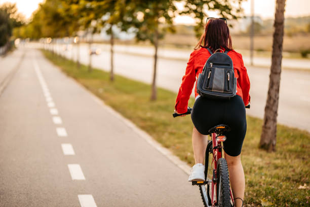 istock Young woman riding a bicycle 1307410751