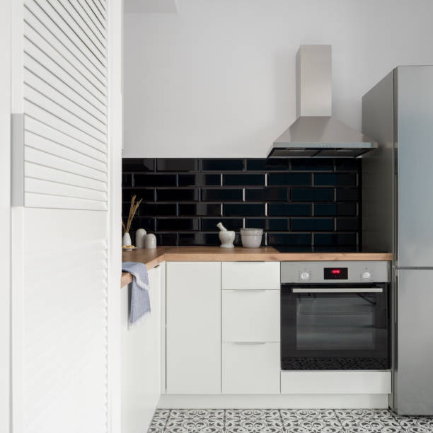 istock Small kitchen with white furniture 1307410988