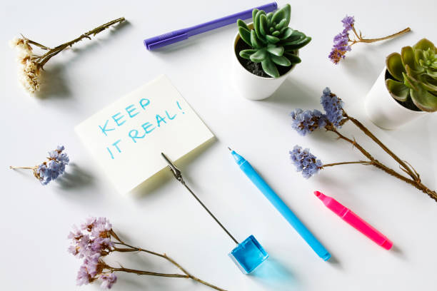 keep it real written on the paper card and flowers composition