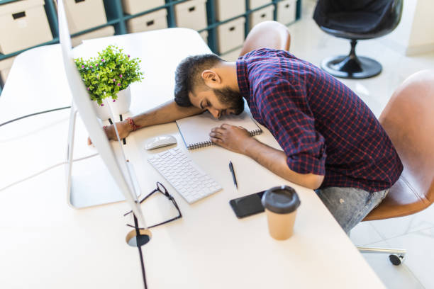 istock Indian Businessman sleeping over working place in office 1307413843