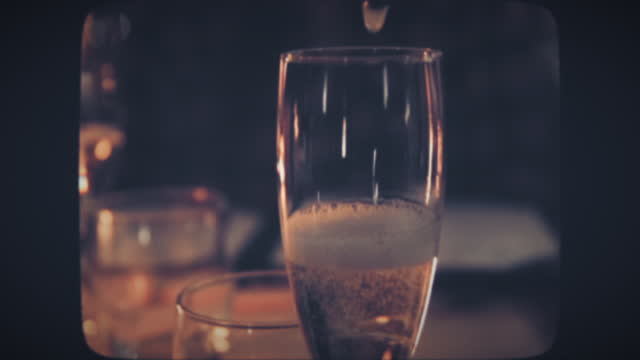 Waiter pouring champagne into glass