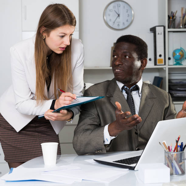 istock Young  woman assistant and man manager working with laptop and papers 1307415544