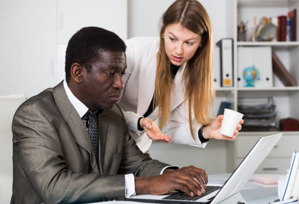 istock Friendly coworkers working together 1307415552