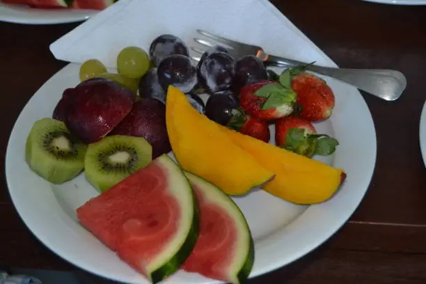 Fresh fruits served on a white plate