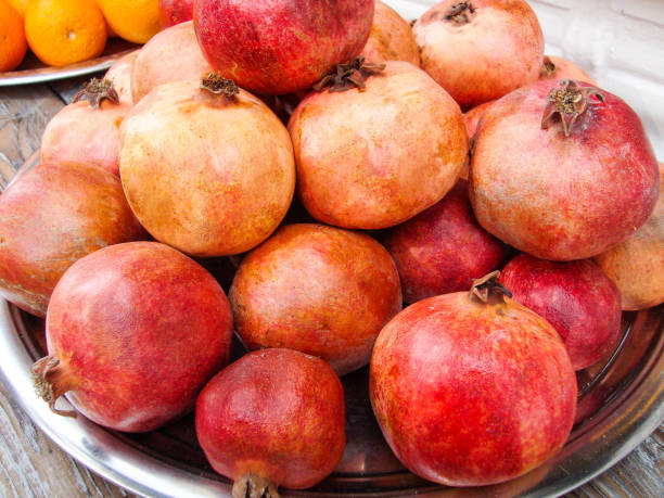 istock ripe pomegranate fruits on a wooden table 1307419677