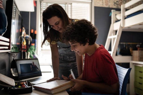 istock Mother helping son with homeschooling 1307419767
