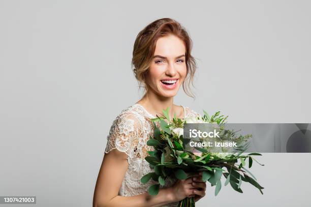 Portrait Of Beautiful Bride Holding Flowers Stock Photo - Download Image Now - Adult, Adults Only, Beautiful People