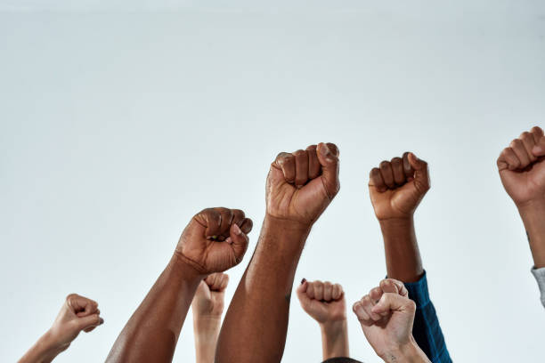 istock Raised hands of multiracial people clenched into fists 1307421005