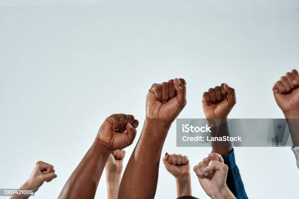 Raised Hands Of Multiracial People Clenched Into Fists Stock Photo - Download Image Now