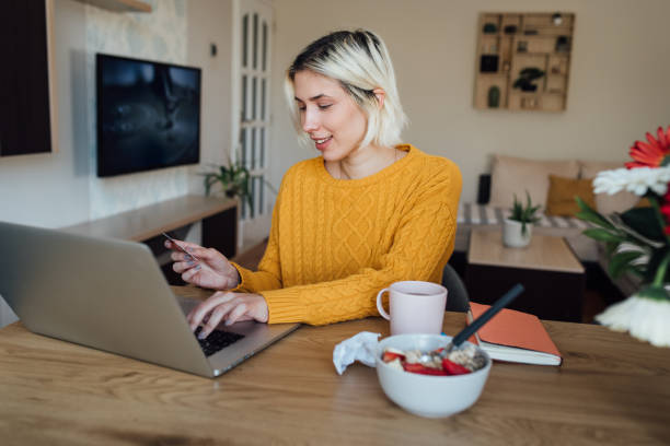 istock Young woman banking at her home office 1307422836