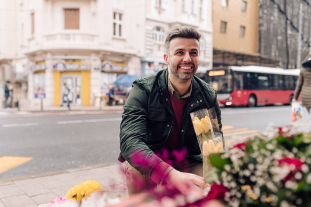 istock Handsome man choosing a bouquet for his wife 1307422881