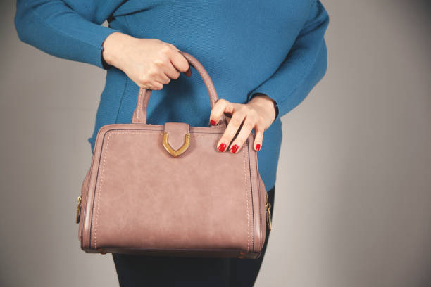 istock woman hand wallet with bag on dark background 1307422915