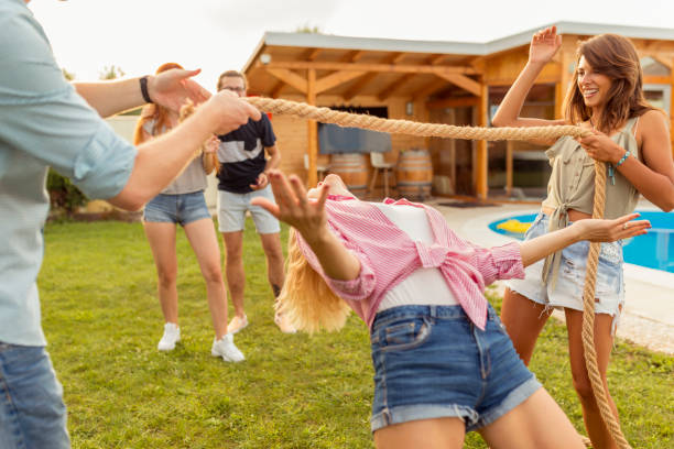 istock Woman doing limbo dance while at poolside summertime outdoor party 1307423991