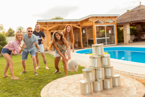 istock Friends playing knock down tin cans game 1307424040