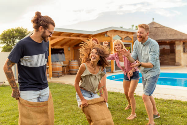 istock Friends having jumping sack race in the backyard 1307424117