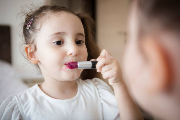 istock Little girl's first lipstick 1307424512