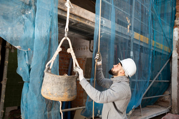istock Worker lifting bucket with cement mortar 1307424812