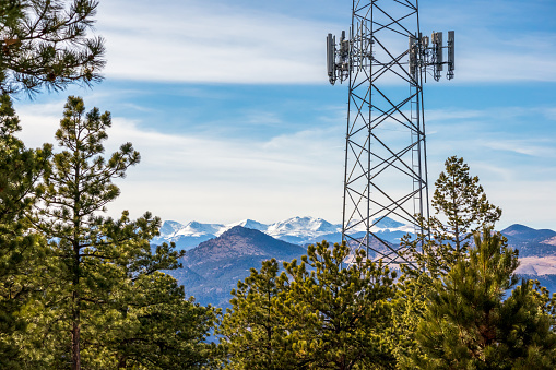 Communication tower with pine trees and the mountain ridge in the background. Lookout Mountain Nature Center and Preserve, Golden, Colorado.