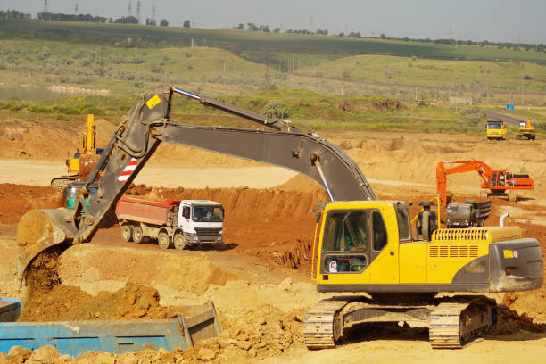 istock Excavation and loading onto dump trucks with excavators. The work of construction equipment in the production of earthworks 1307427442