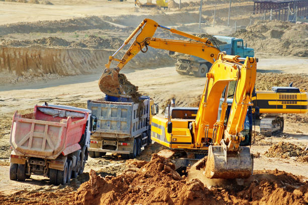 istock Excavation and loading onto dump trucks with excavators. The work of construction equipment in the production of earthworks 1307427467