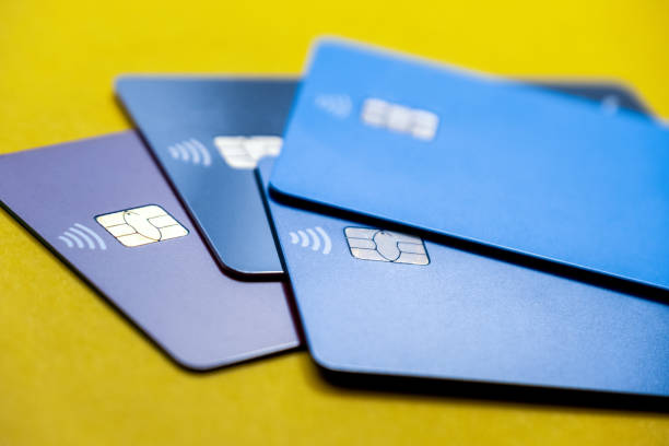 Still life blue credit cards on a yellow background stock photo