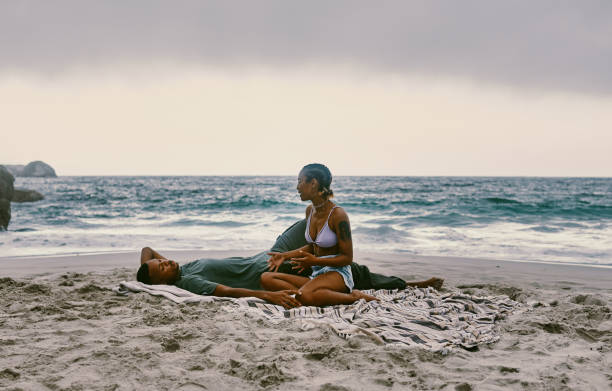 Shot of a young couple spending the day together at the beach