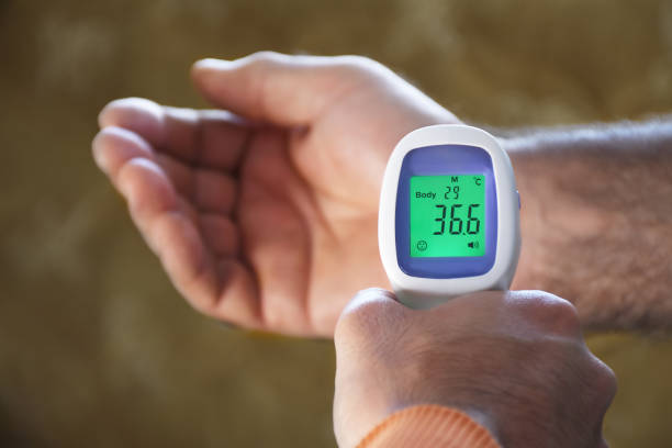 istock Hand measuring the old men's temperature 1307429629