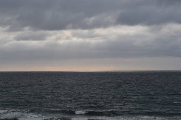 istock Moody Ocean Sky with Clouds and Light Rays 1307431116