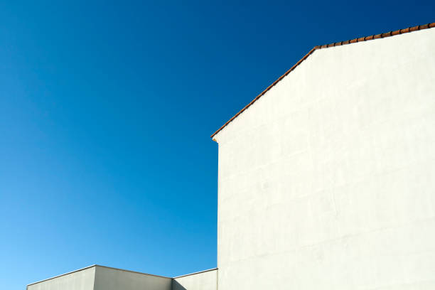istock White wall silhouettes in front of blue sky 1307431269