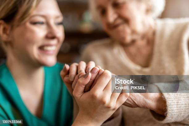 Cropped Shot Of A Senior Woman Holding Hands With A Nurse Stock Photo - Download Image Now