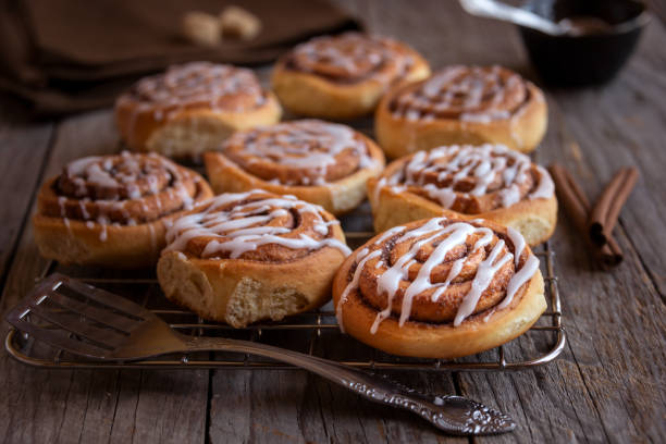 istock Fresh home baked sweet cinnamon buns with frosting 1307433779