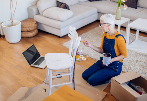 istock Mature woman watching online tutorials and restoring an old chair 1307433931