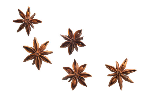 flying anise stars isolated on white background flying anise stars isolated on white background anise stock pictures, royalty-free photos & images