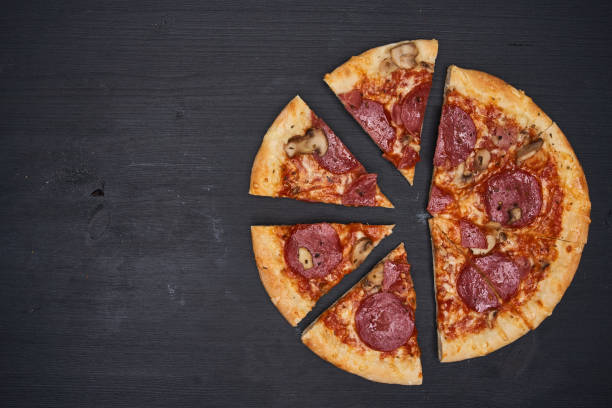 istock Delicious pizza on wooden board 1307436743