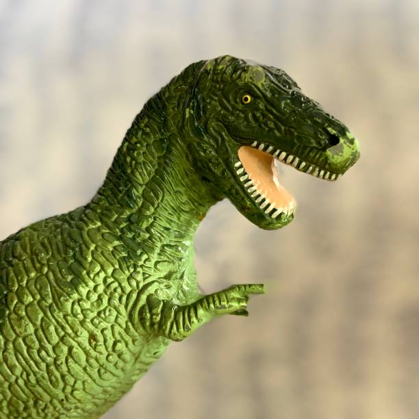 istock Vintage Toy Dinosaur with Broken Front Foot 1307437028