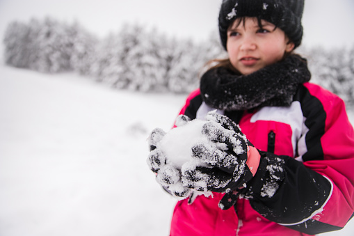 Young girl with a snowball