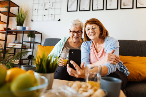 istock Senior women at home using smart phone. Seniors and technologies - senior women using internet and smart phone to communicate with family 1307437719