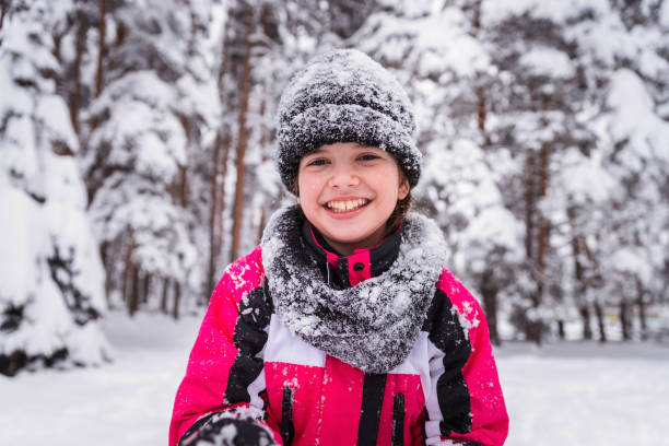 istock Girl standing on snow and laughing 1307437953