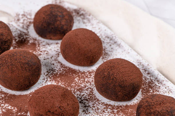 istock Fine chocolate truffles on white ceramic plate. 1307438036