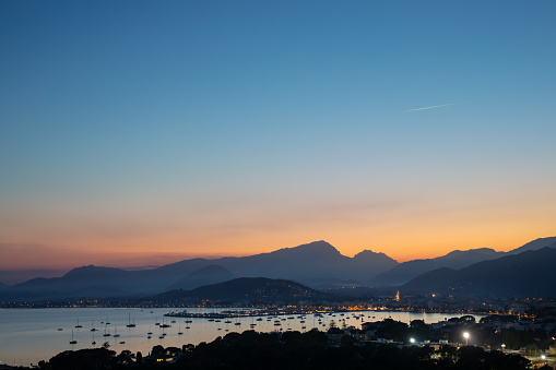 The beautiful port of Pollensa in Mallorca in the evening at a colorfull sunset.