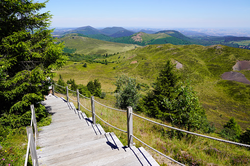 wooden pedestrian walking pathway in puy-de-dome french mountain chain volcano