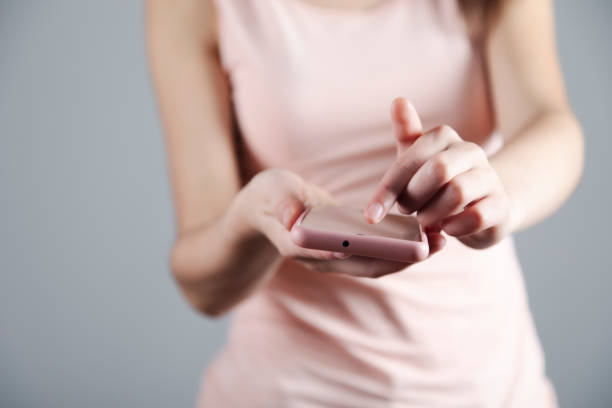 istock young woman holding smart phone 1307441419