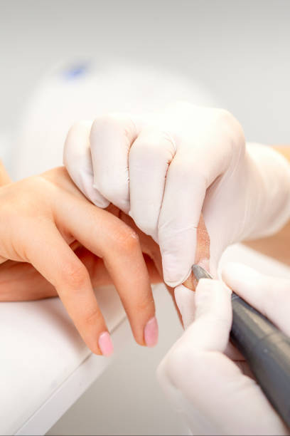 istock Manicurist removing old nail polish 1307441819