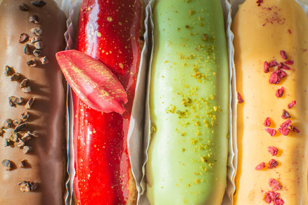 istock Eclairs chocolate, raspberry, pistachio and lemon close-up. Hello sweet mood. Concept baking, cookbook recipes, bakery banner, cafe advertisement. Vacation sales summer and holiday. 1307443961