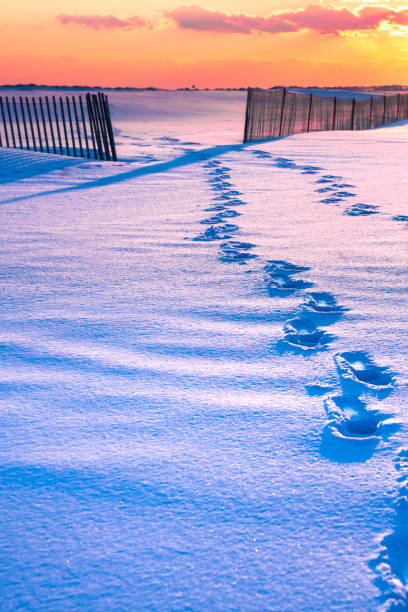 Winter scene under color sky at sunset on snow covered beach. Jones Beach State Park., Long Island NY