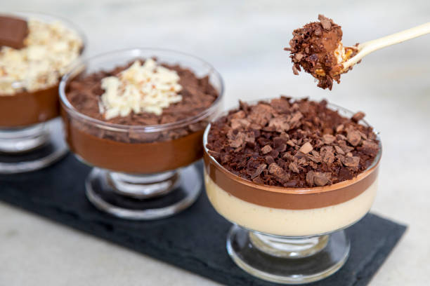 istock Chocolate mousse on spoon with white chocolate shavings 1307447406