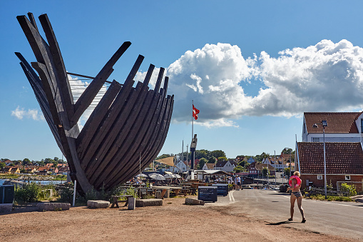 Pak Asbahari, a 54-year-old boat craftsman, is seen here meticulously crafting a wooden fishing boat along the banks of the Krueng Aceh River, Banda Aceh, Indonesia, on August 3, 2023. The construction of wooden fishing boats is a crucial activity in the fishing industry. Workers involved in boat making must possess specialized skills in wood processing and precise assembly to ensure the vessels function effectively and safely at sea. Working alone from dawn till dusk, Pak Asbahari relies solely on his expertise honed over years. Spending seven months crafting this vessel since its inception, he anticipates its completion by the end of 2024.