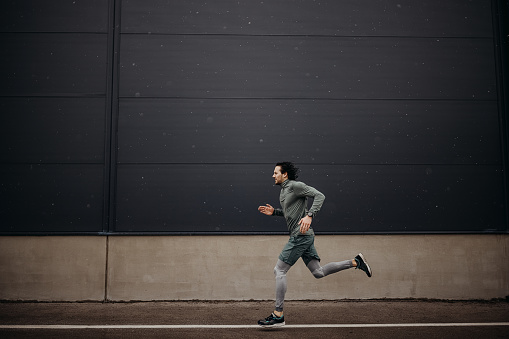 Young sports men running in rainy day, modern and healthy men lifestyle