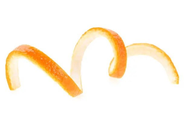 Photo of Orange twist isolated on a white background. Orange peel close-up. Orange citron.